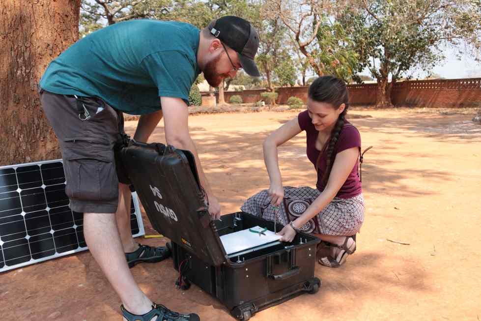 2 people working on a solar battery pack